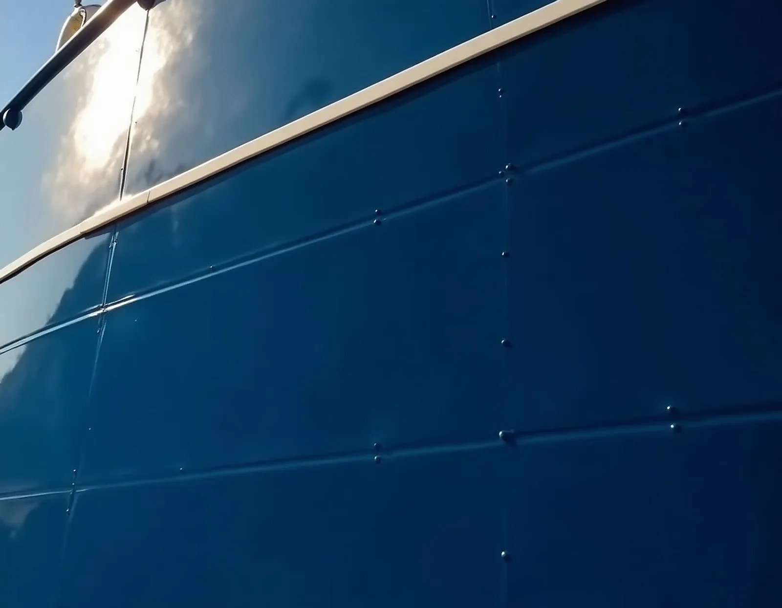 Freshly painted glossy navy blue ship hull plating